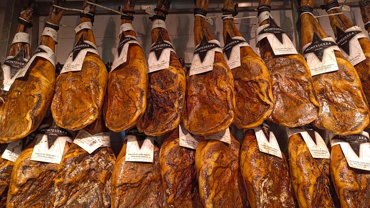A detailed view of hanging Jamón Ibérico hams in a traditional setting.